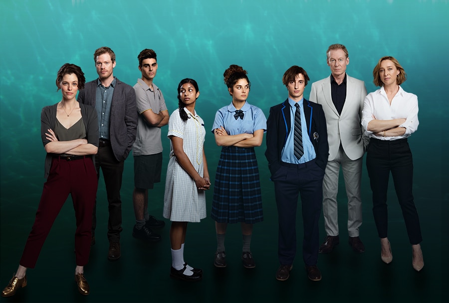 Group of students standing next to parents and teachers