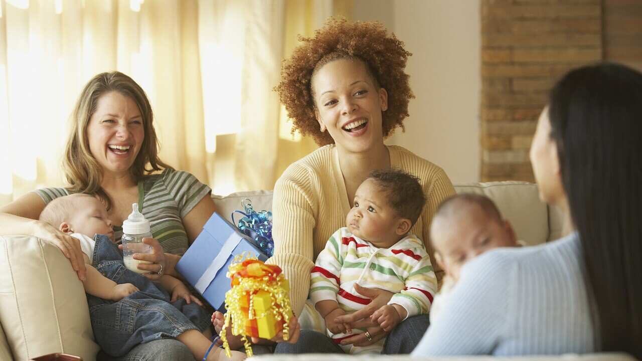 Young mothers with babies and gifts.